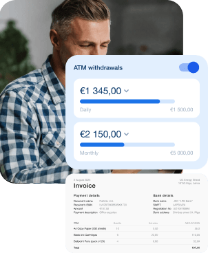 A man looks at his phone while checking ATM withdrawal limits on a mobile app