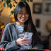 Smiling woman with smartphone
