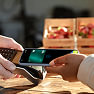 A person holds a phone to a payment terminal