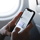Person using a smartphone to browse social media while sitting on an airplane